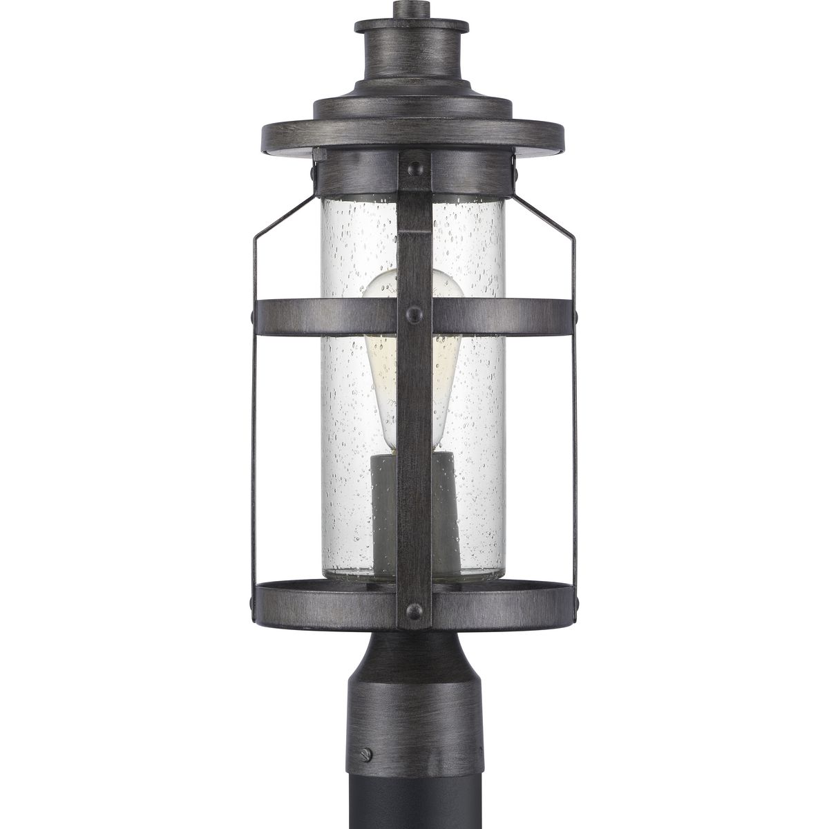 The one-light post lantern in the Haslett Collection features a design with intersecting linear details that surrounds clear seeded glass and finished in Antique Pewter. Coastal-inspired frame is suitable to complement architecture with Farmhouse flair.