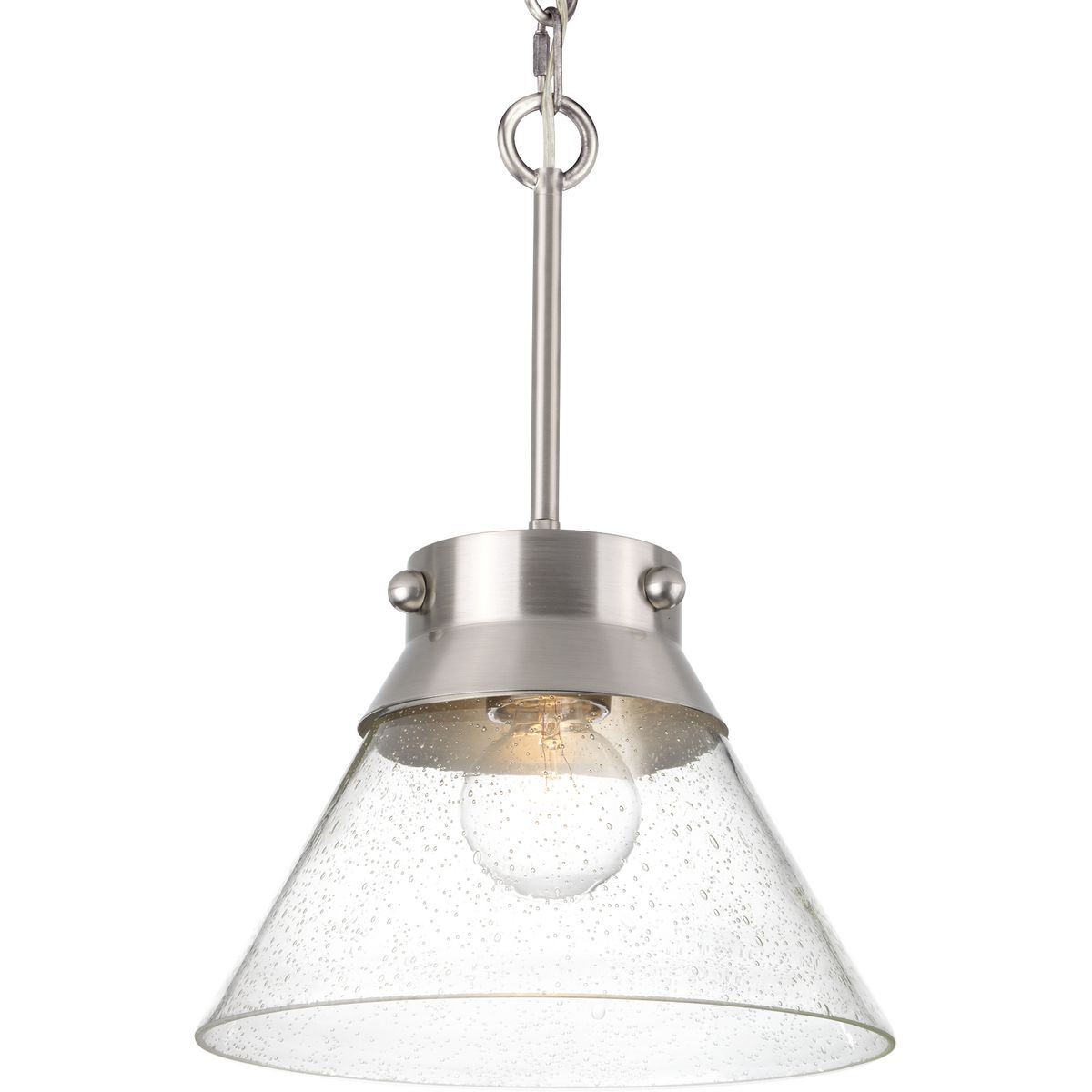 With an interesting mix of Farmhouse design and industrial, almost nautical details, the Tapia Trail pendant is Americana style at its best. A banded metal collar accented with rivets in Brushed Nickel call out to its Coastal nautical origins and is attached via a hook for an added industrial style. A flared, seeded glass shade finishes the look with a charming Farmhouse touch. This family of fixtures is part of the Jeffrey Alan Marks Point Dume� lighting collection which celebrates a curated mix of yesterday and today, distilling both industrial and artisanal influences.