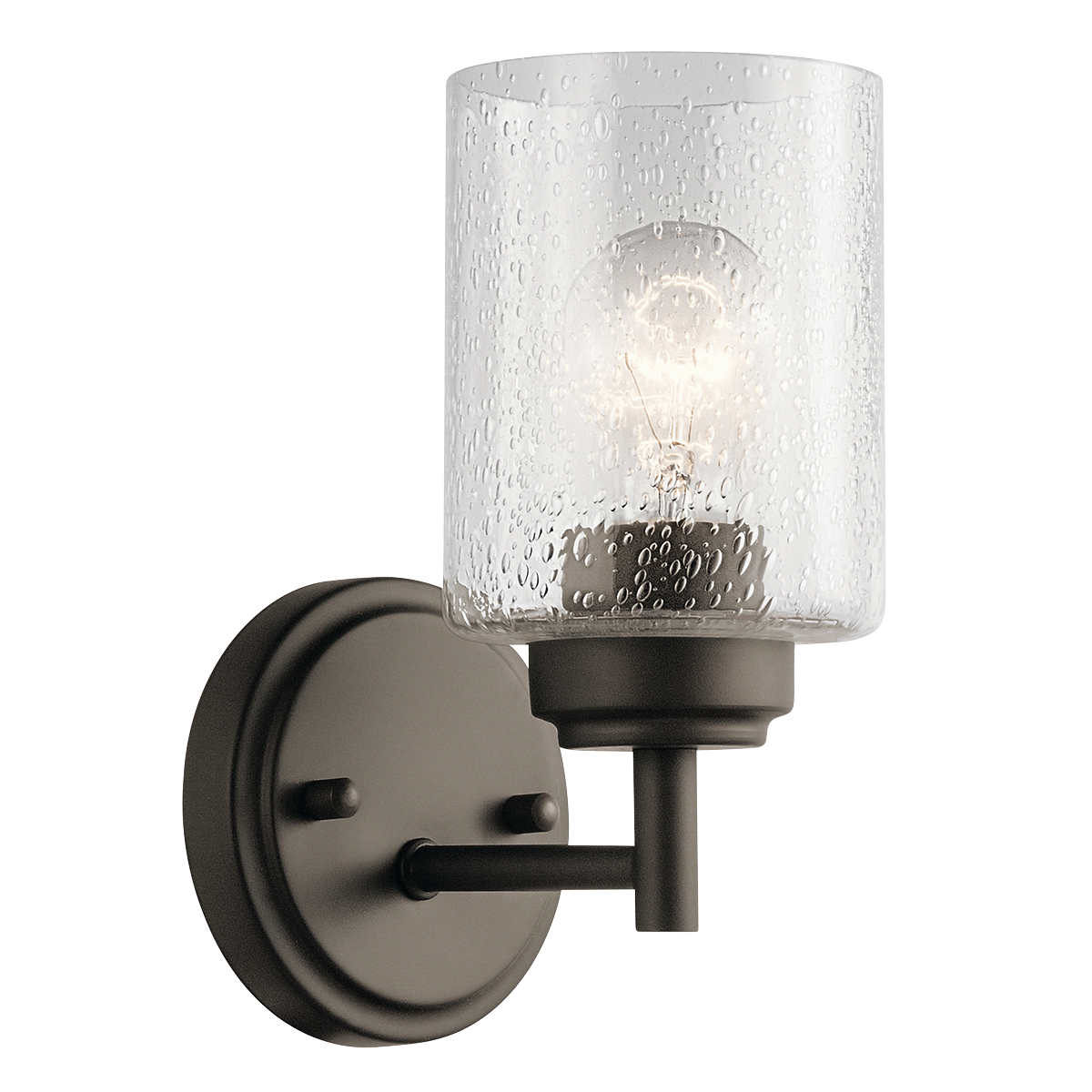 The modern Winslow 1-light wall sconce in an Olde Bronze finish with Clear Seeded glass shade pair beautifully with the linear arms, bringing light and dimension to a space.